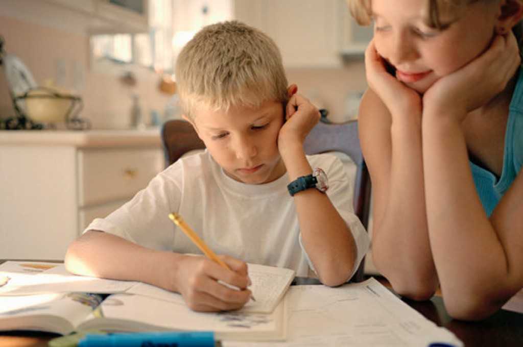 Реально домашнее задание. Ребенок за уроками. Ребенок сосредоточен. Подросток за уроками. Ребенок учит уроки.